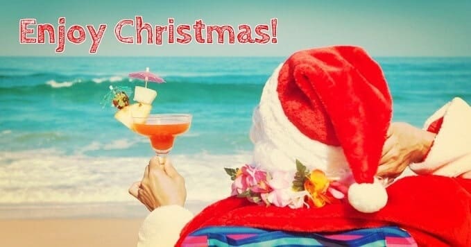 Santa Claus drinking a cocktail on the beach
