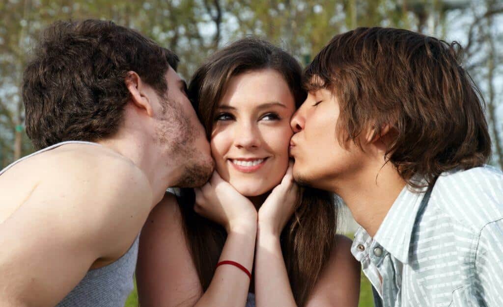 two men kiss a woman because they are in an open distance relationship